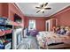 Spacious bedroom with red walls and a ceiling fan, filled with colorful toys and furniture at 2507 Maple St, Atlanta, GA 30344