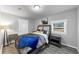 Cozy bedroom with a grey wood floor, blue throw, and an animal art piece at 2507 Maple St, Atlanta, GA 30344