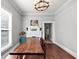 Airy dining room features hardwood floors, decorative fireplace, and modern light fixture at 2507 Maple St, Atlanta, GA 30344