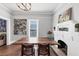 Bright dining room with hardwood floors, decorative fireplace, and modern artwork at 2507 Maple St, Atlanta, GA 30344