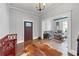 Stylish foyer with hardwood floors, decorative doorway and a peek into the cozy living space at 2507 Maple St, Atlanta, GA 30344