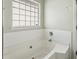 Bathroom with bathtub and tiled walls needs minor renovation at 4160 Alveston Dr, Atlanta, GA 30349