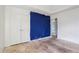 Room with double doors and blue accent wall at 4160 Alveston Dr, Atlanta, GA 30349