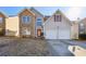 Two-story house with stone and vinyl siding, two-car garage at 4160 Alveston Dr, Atlanta, GA 30349