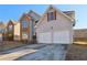 Two-story house with stone accents and a two-car garage at 4160 Alveston Dr, Atlanta, GA 30349
