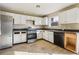 A kitchen with white cabinets, stainless steel appliances, and tile flooring at 4160 Alveston Dr, Atlanta, GA 30349