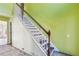A staircase with wooden handrail and green painted wall at 4160 Alveston Dr, Atlanta, GA 30349