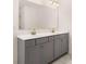 Bathroom showcasing double vanity with gray cabinets, light countertops and modern hardware at 13520 Whitman Lane, Covington, GA 30014