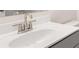 Close-up on a white bathroom sink featuring a modern faucet and neutral countertop at 13520 Whitman Lane, Covington, GA 30014