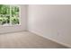 Carpeted bedroom with natural light from the window overlooking the trees outside at 13520 Whitman Lane, Covington, GA 30014