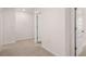 Hallway features neutral carpet, white walls, and various white interior doors at 13520 Whitman Lane, Covington, GA 30014