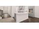 A kitchen features gray cabinets, an island with a white countertop, and wood-look floors at 13520 Whitman Lane, Covington, GA 30014