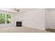 This bright room has a white fireplace and large windows overlooking a lush green backyard at 13520 Whitman Lane, Covington, GA 30014