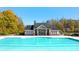 Community pool and clubhouse surrounded by autumn foliage, offering a relaxing atmosphere at 13520 Whitman Lane, Covington, GA 30014