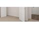 Carpeted space with a white interior door leading to a carpeted area at 13520 Whitman Lane, Covington, GA 30014