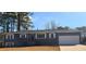 Newly renovated ranch home featuring a gray exterior, white garage door, and landscaped lawn at 1800 Pinedale Nw Dr, Atlanta, GA 30314