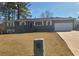 Ranch style home with gray exterior, white garage door, and well-maintained lawn at 1800 Pinedale Nw Dr, Atlanta, GA 30314