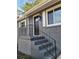 Gray brick front entry with black metal railing and dark brown door at 1800 Pinedale Nw Dr, Atlanta, GA 30314