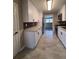 Modern kitchen with white cabinets, stainless steel appliances, and tile flooring at 1800 Pinedale Nw Dr, Atlanta, GA 30314