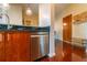 Modern kitchen with stainless steel dishwasher and dark wood cabinets at 361 17Th St # 2001, Atlanta, GA 30363