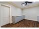 Basement room with hardwood floors, built-in cabinets, and ceiling fan at 344 Carmichael Cir, Canton, GA 30115