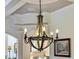 Ornate wooden chandelier with six lights, perfect for a dining room or kitchen at 1891 Prospect Church Rd, Lawrenceville, GA 30043
