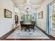 Elegant dining room featuring a large table, chandelier, hardwood floors, and large windows at 1891 Prospect Church Rd, Lawrenceville, GA 30043
