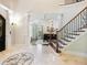 Grand entryway with tile flooring and curved staircase at 1891 Prospect Church Rd, Lawrenceville, GA 30043