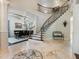Elegant two-story entryway with a curved staircase and mosaic flooring at 1891 Prospect Church Rd, Lawrenceville, GA 30043