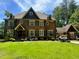 Brick house with large windows, stone accents, and a manicured lawn at 1891 Prospect Church Rd, Lawrenceville, GA 30043