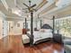 Main bedroom with hardwood floors, large windows, and a ceiling fan at 1891 Prospect Church Rd, Lawrenceville, GA 30043