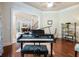 Music room with hardwood floors, digital piano, and built-in shelving at 1891 Prospect Church Rd, Lawrenceville, GA 30043