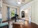 Music room with hardwood floors, piano, and view of the entryway at 1891 Prospect Church Rd, Lawrenceville, GA 30043