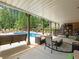 Covered patio with seating area overlooking the pool at 1891 Prospect Church Rd, Lawrenceville, GA 30043