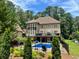 Inviting backyard oasis with a swimming pool, deck, and lush landscaping at 1891 Prospect Church Rd, Lawrenceville, GA 30043