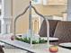 White candles and greenery centerpiece in a rustic metal holder on dining table at 1891 Prospect Church Rd, Lawrenceville, GA 30043