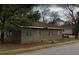 Side view of a one-story stucco home needing renovation at 868 Oakhill Sw Ave, Atlanta, GA 30310