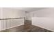 Upstairs hallway with dark hardwood floors and white railings at 13547 Whitman Ln, Covington, GA 30014