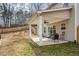 Covered patio and fenced backyard with wooded views at 66 Vicky Way, Douglasville, GA 30134