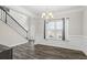 Bright dining room with wainscoting, hardwood floors, and a large window at 66 Vicky Way, Douglasville, GA 30134