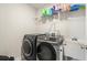 Laundry room with washer, dryer, utility sink and shelving at 66 Vicky Way, Douglasville, GA 30134