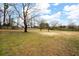Large backyard with fenced perimeter and mature trees at 44 Browns Ct, Powder Springs, GA 30127