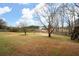 Large backyard with fenced perimeter and mature trees at 44 Browns Ct, Powder Springs, GA 30127