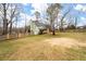 House backyard view with fenced perimeter and mature trees at 44 Browns Ct, Powder Springs, GA 30127