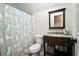 Clean bathroom with a cat-themed shower curtain and granite countertop at 44 Browns Ct, Powder Springs, GA 30127