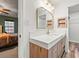 Modern bathroom with a floating vanity, quartz countertop and gold fixtures at 44 Browns Ct, Powder Springs, GA 30127