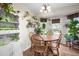 Bright dining area with wooden table and chairs, featuring a built-in hutch and abundant plants at 44 Browns Ct, Powder Springs, GA 30127