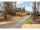 House exterior with long driveway and landscaping at 44 Browns Ct, Powder Springs, GA 30127
