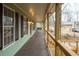 Long front porch with wooden railings and a view of the backyard at 44 Browns Ct, Powder Springs, GA 30127