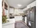 Modern kitchen with white cabinets, granite countertops, and stainless steel appliances at 44 Browns Ct, Powder Springs, GA 30127